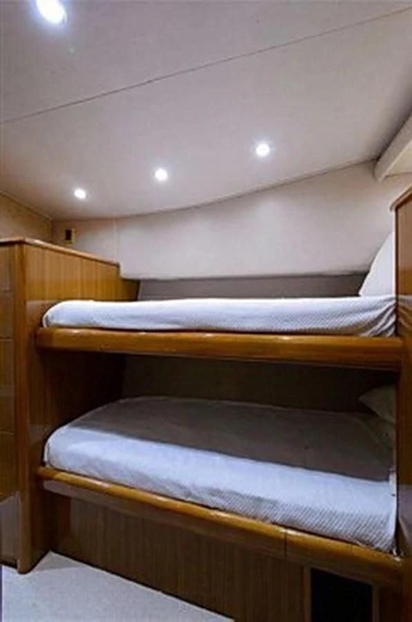 a bed with a wooden headboard aboard DON'T STOP BELIEVIN Yacht for Sale