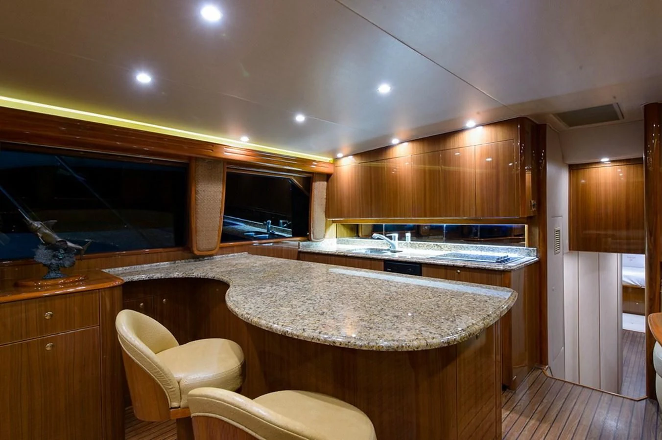 a kitchen with a bar and stools aboard DON'T STOP BELIEVIN Yacht for Sale
