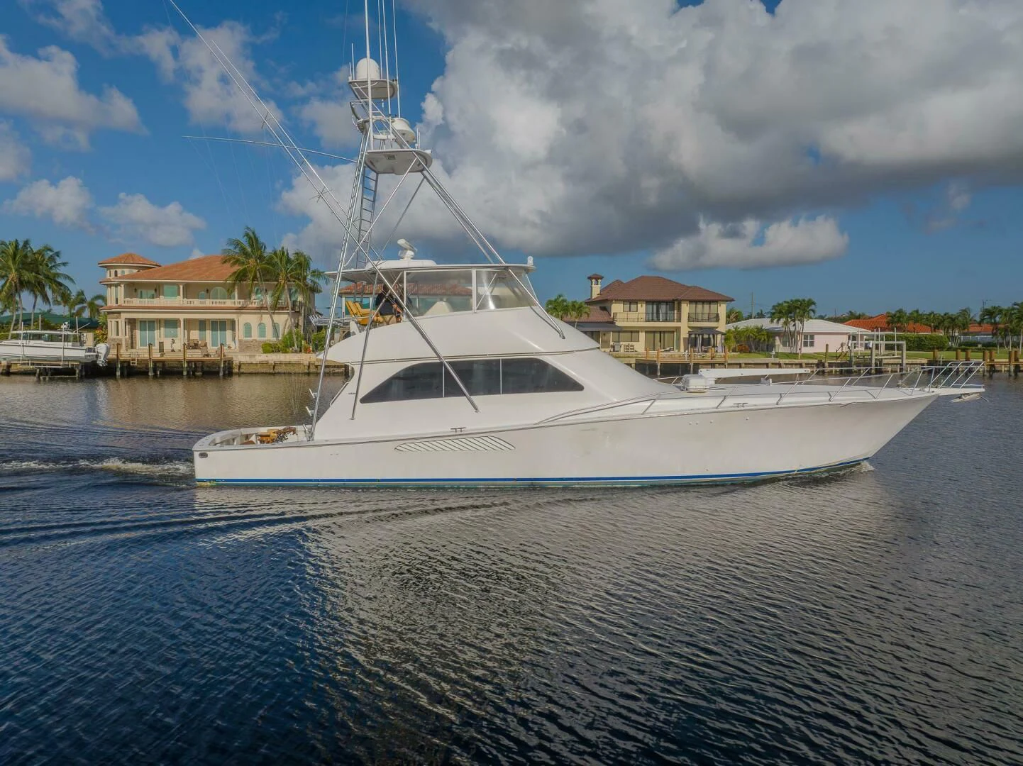 a white boat in a harbor aboard DON'T STOP BELIEVIN Yacht for Sale