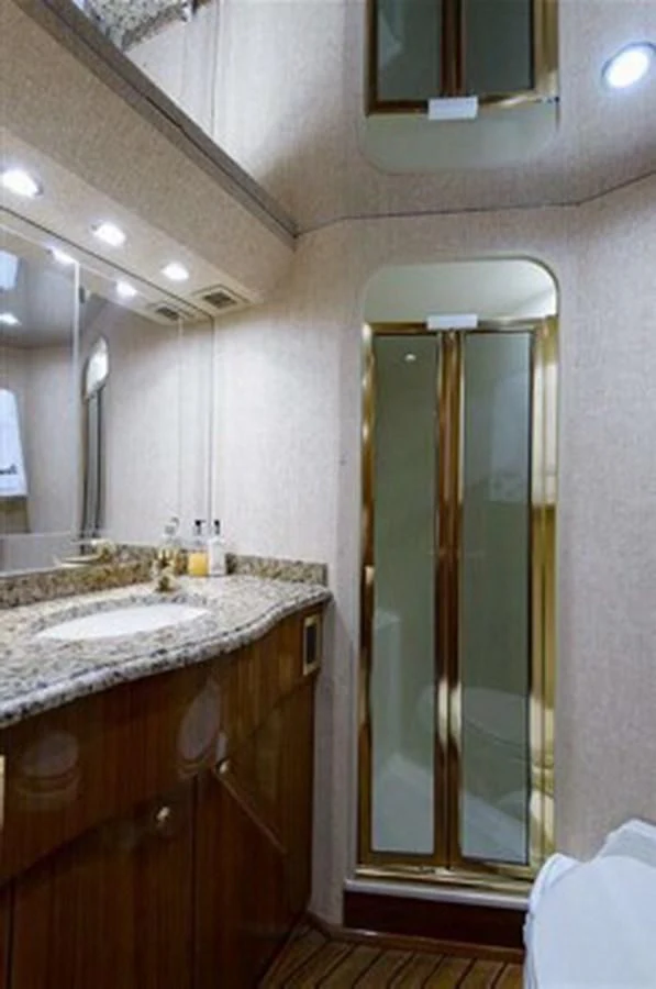 a bathroom with a glass shower door aboard DON'T STOP BELIEVIN Yacht for Sale