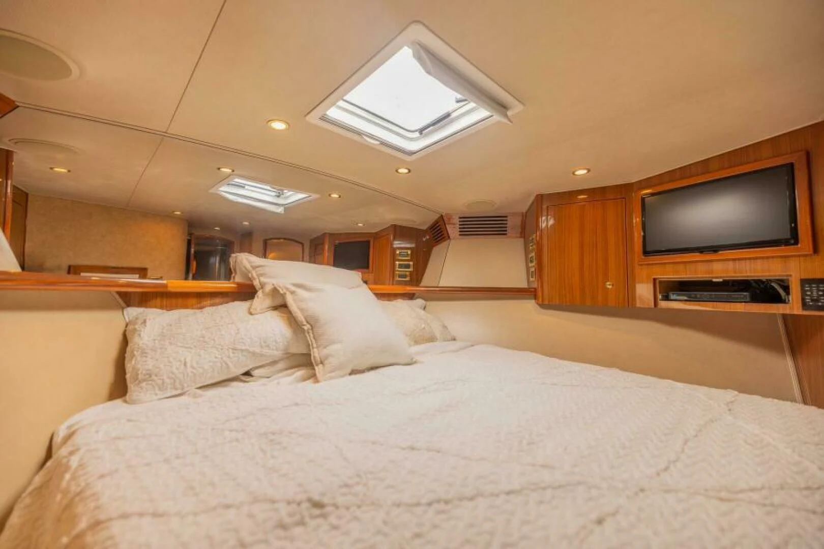 a bed with a television on the wall aboard DON'T STOP BELIEVIN Yacht for Sale