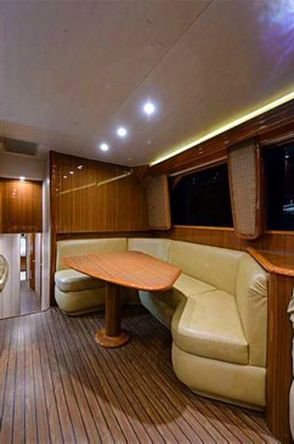 a room with a table and couch aboard DON'T STOP BELIEVIN Yacht for Sale