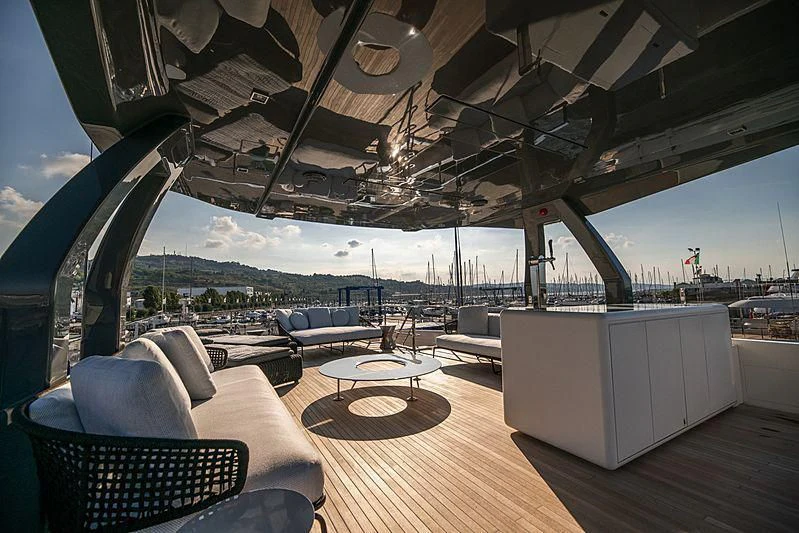 a large lounge area with a large patio and a large white building with a large glass window with aboard SK Yacht for Sale