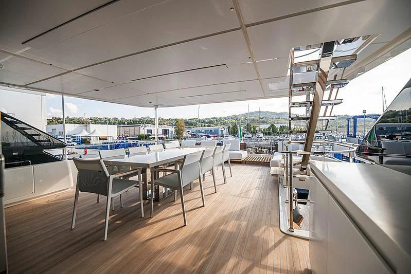 a room with tables and chairs aboard SK Yacht for Sale