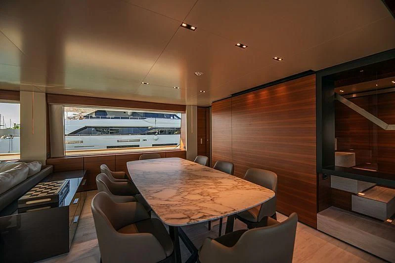 a room with a table and chairs aboard SK Yacht for Sale