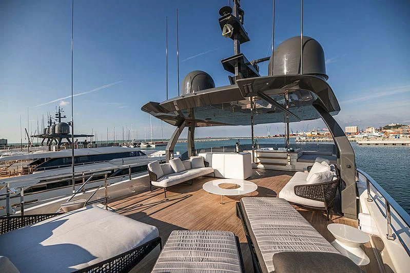 a deck with a large ship in the background aboard SK Yacht for Sale