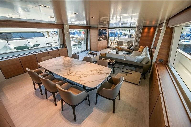 a room with a table and chairs aboard SK Yacht for Sale