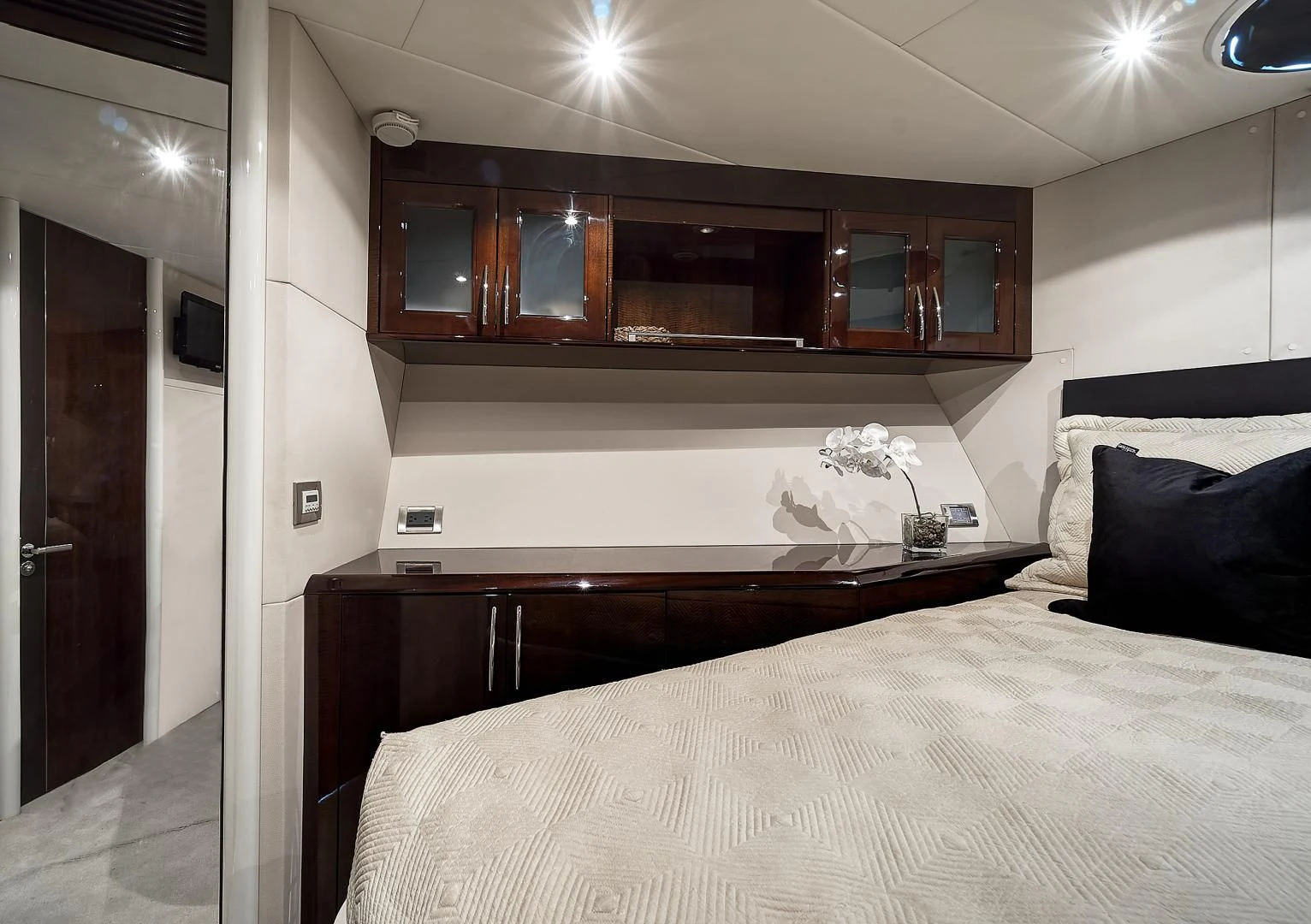 a bed with a white bed spread aboard LADY H Yacht for Sale