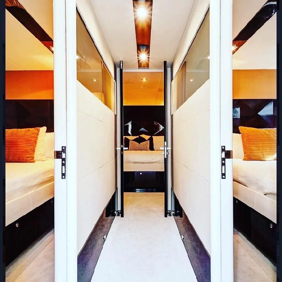 a room with white walls and a bed aboard LADY H Yacht for Sale