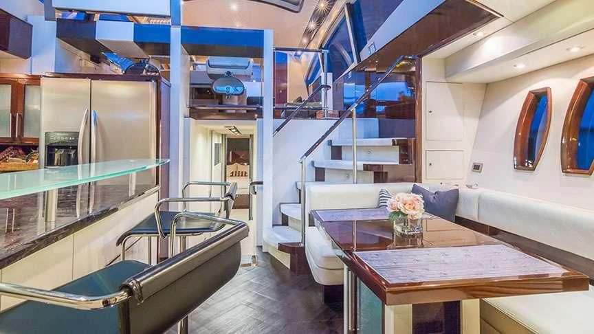 a room with a table and chairs aboard LADY H Yacht for Sale