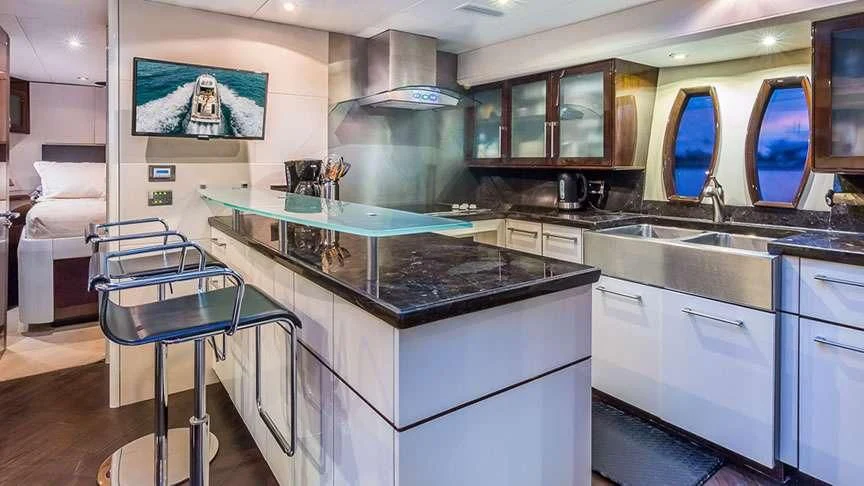 a kitchen with a bar and a table aboard LADY H Yacht for Sale