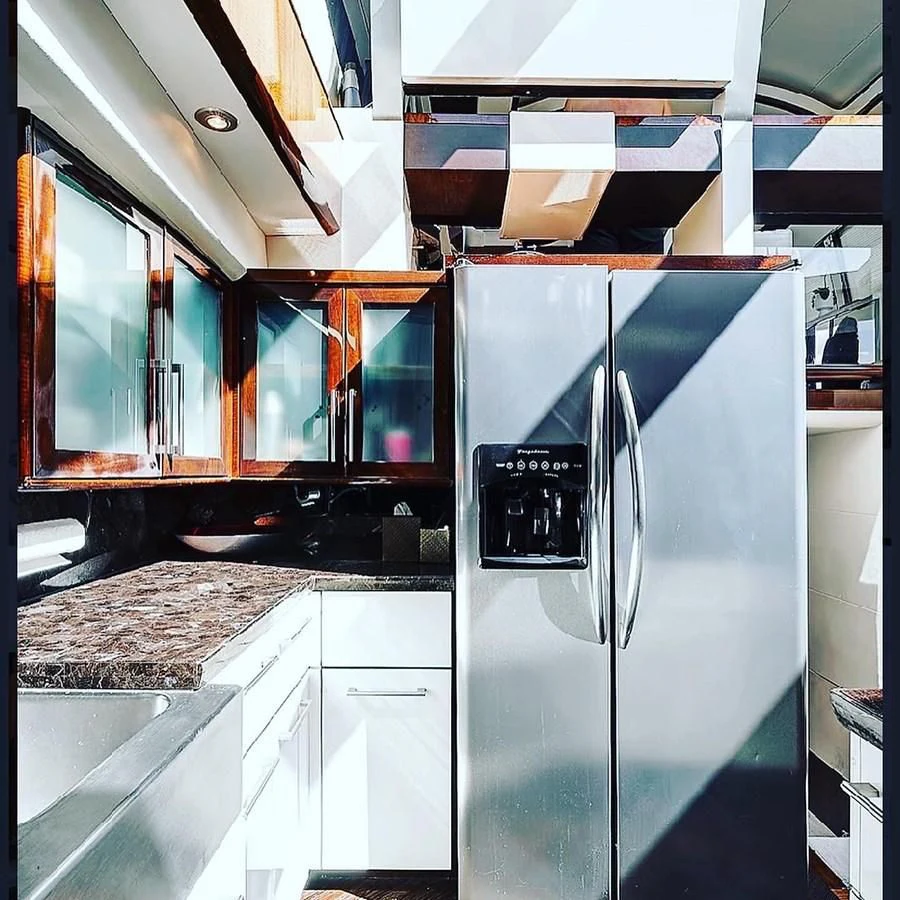 a kitchen with a refrigerator aboard LADY H Yacht for Sale