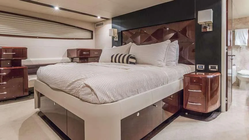 a bed with a white sheet aboard LADY H Yacht for Sale