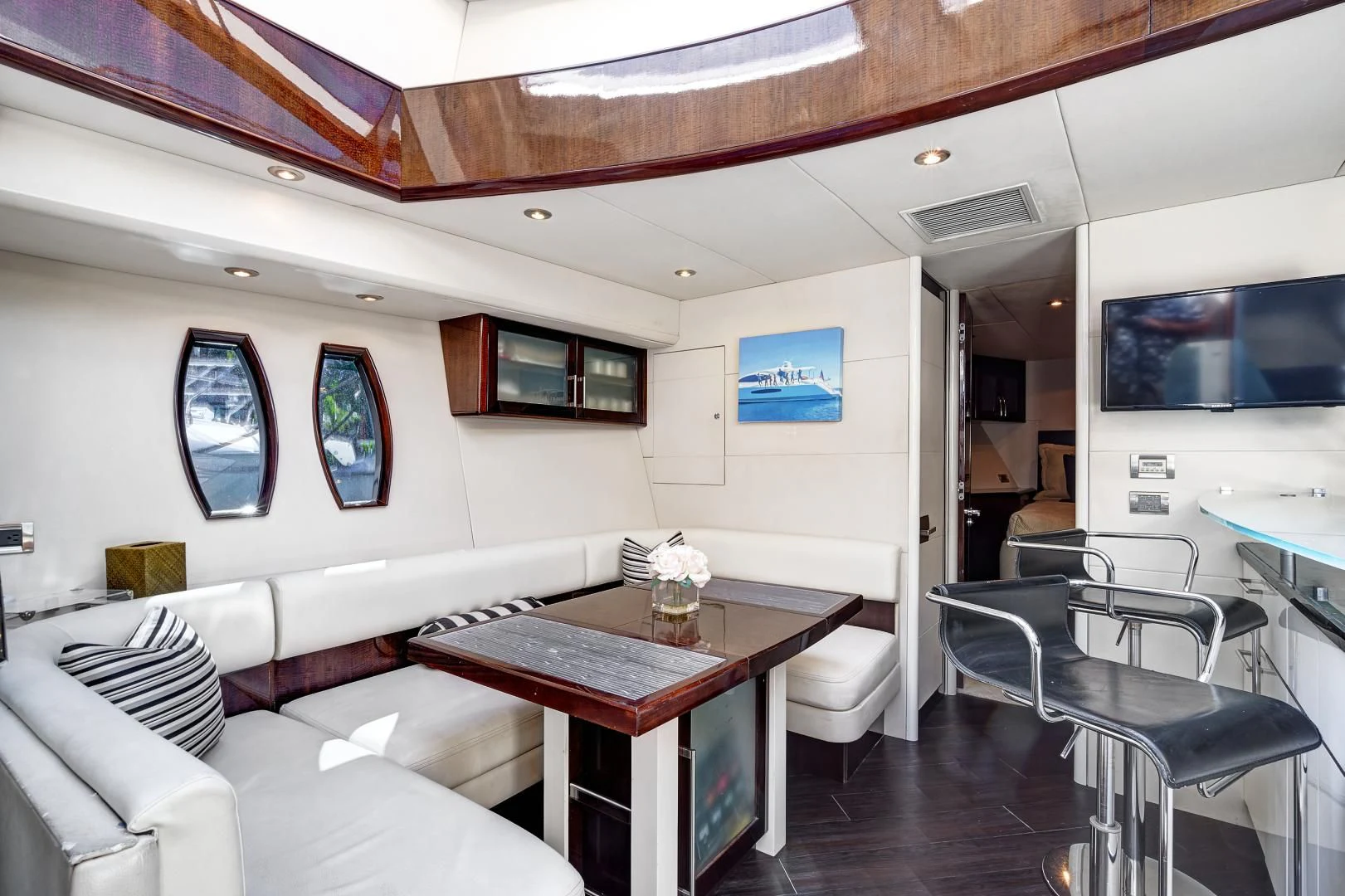 a living room with a table and chairs aboard LADY H Yacht for Sale