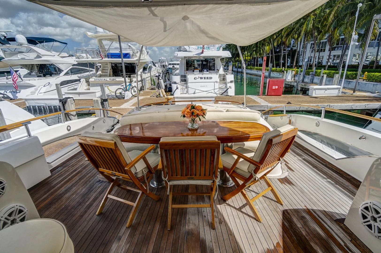 a deck with chairs and tables on it aboard LADY H Yacht for Sale