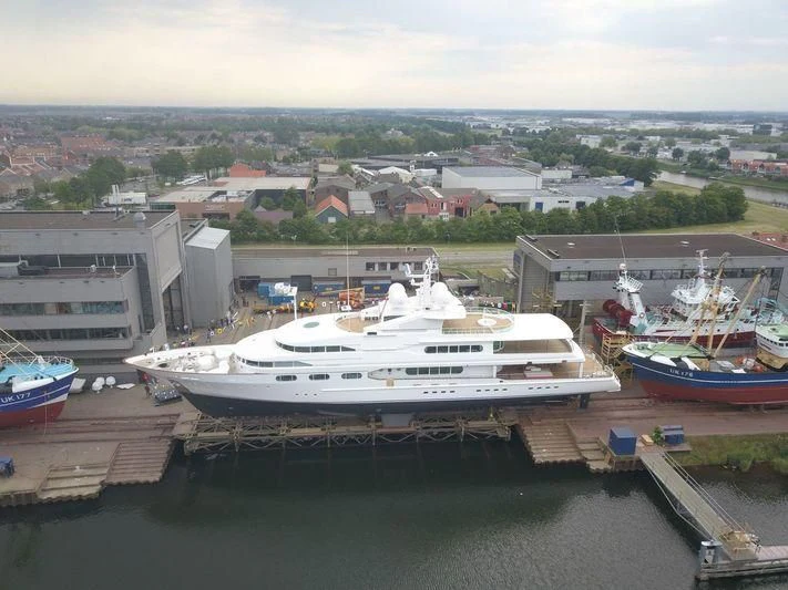 a large white boat sits in a harbor aboard DANCING HARE Yacht for Sale