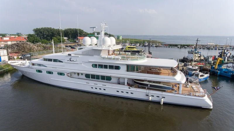 a large white boat in a harbor aboard DANCING HARE Yacht for Sale