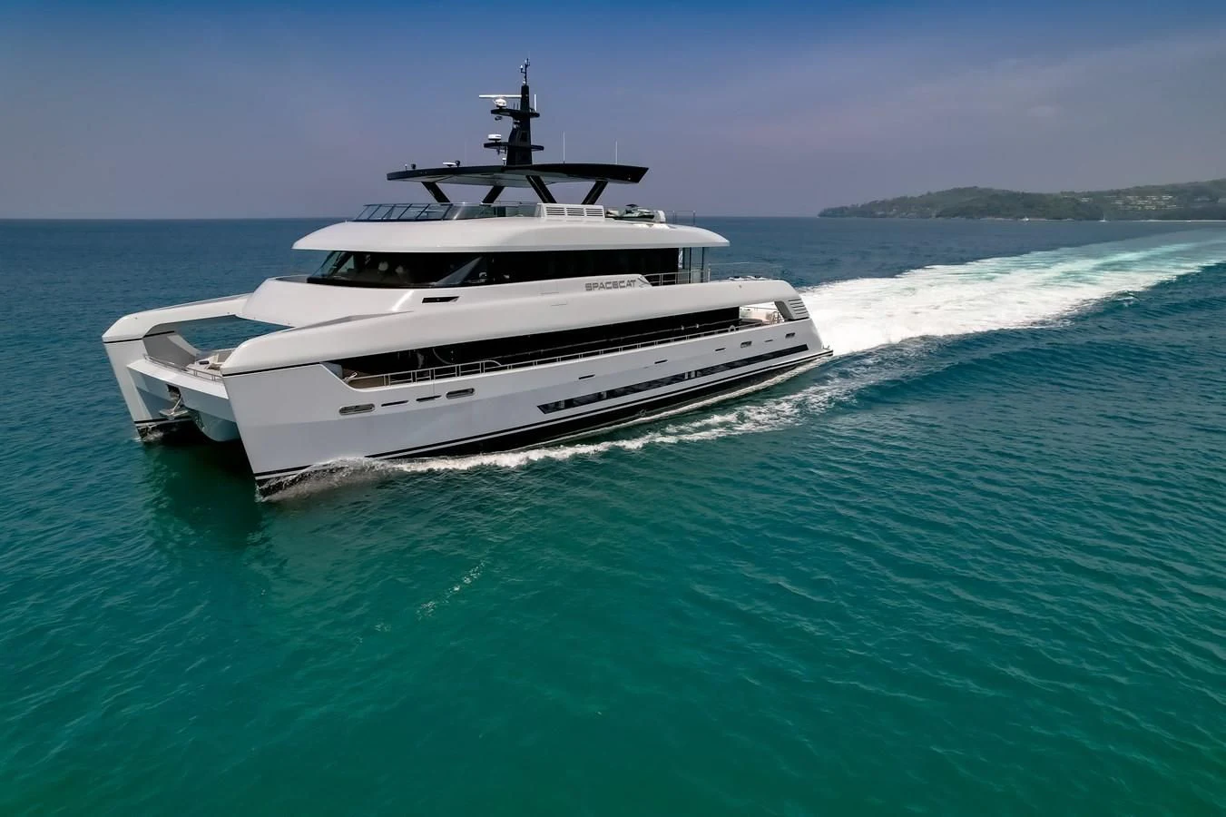 a white yacht in the water aboard SPACECAT Yacht for Sale