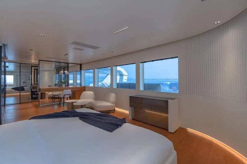 a modern bedroom with a large window aboard SPACECAT Yacht for Sale
