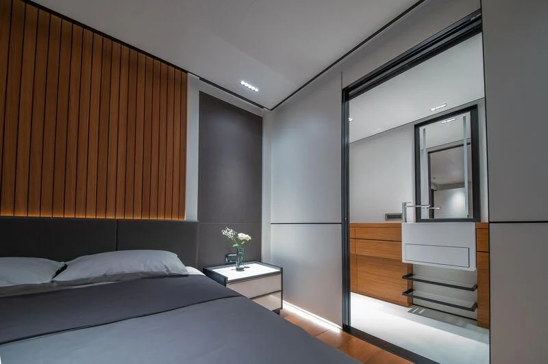 a room with a bed and a desk aboard SPACECAT Yacht for Sale