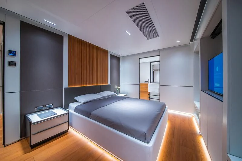 a bedroom with a large bed aboard SPACECAT Yacht for Sale