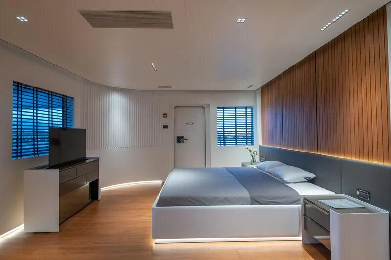 a room with a bed and a tv aboard SPACECAT Yacht for Sale