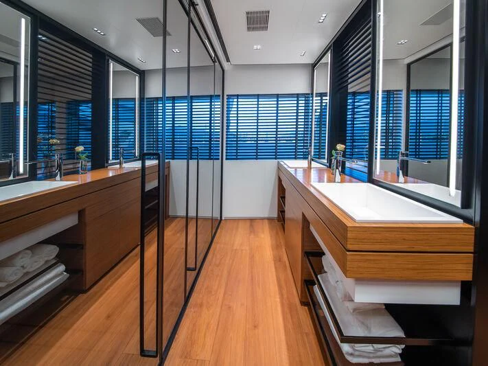 a room with a wood floor and a large window with a wood floor aboard SPACECAT Yacht for Sale