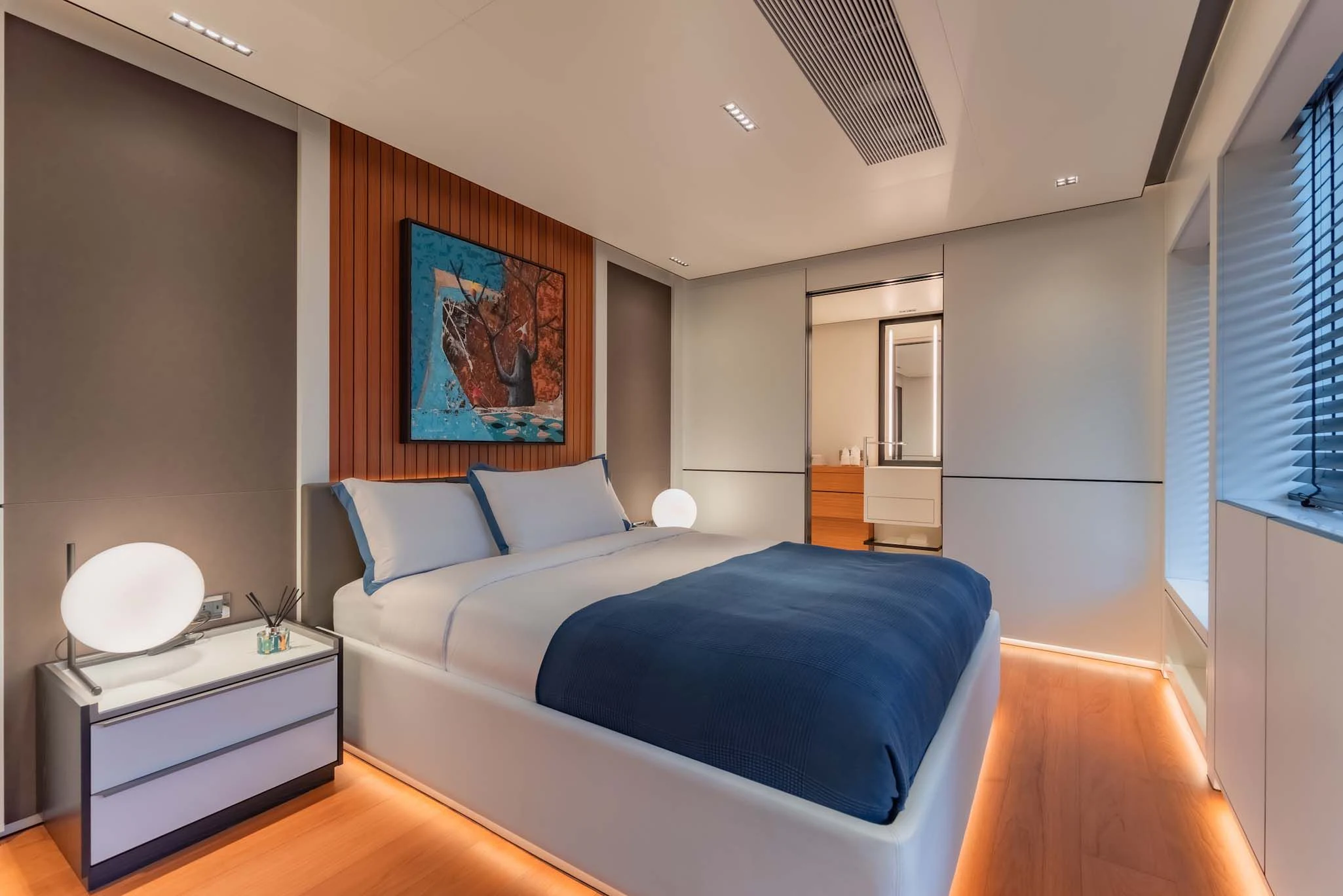 a bedroom with a bed and a desk aboard SPACECAT Yacht for Sale