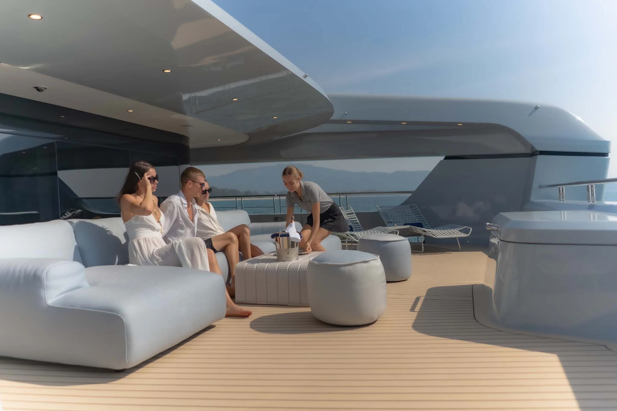 a group of people sitting around a table aboard SPACECAT Yacht for Sale