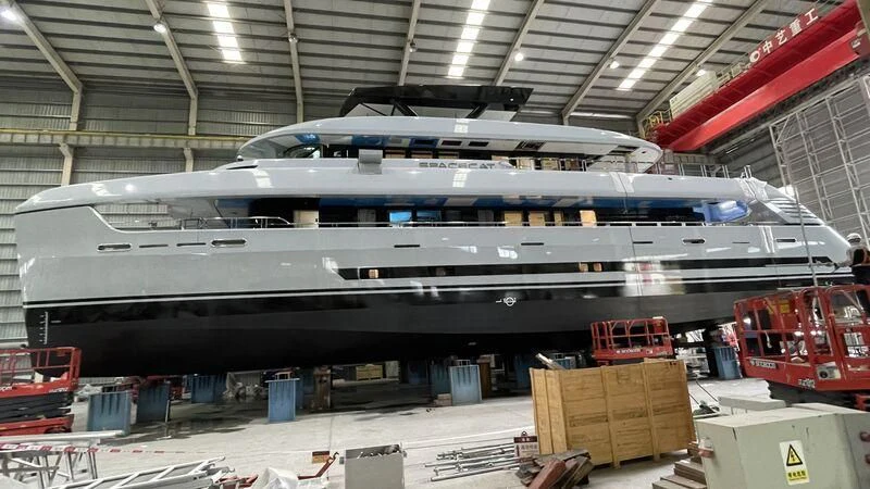 a large airplane in a warehouse aboard SPACECAT Yacht for Sale