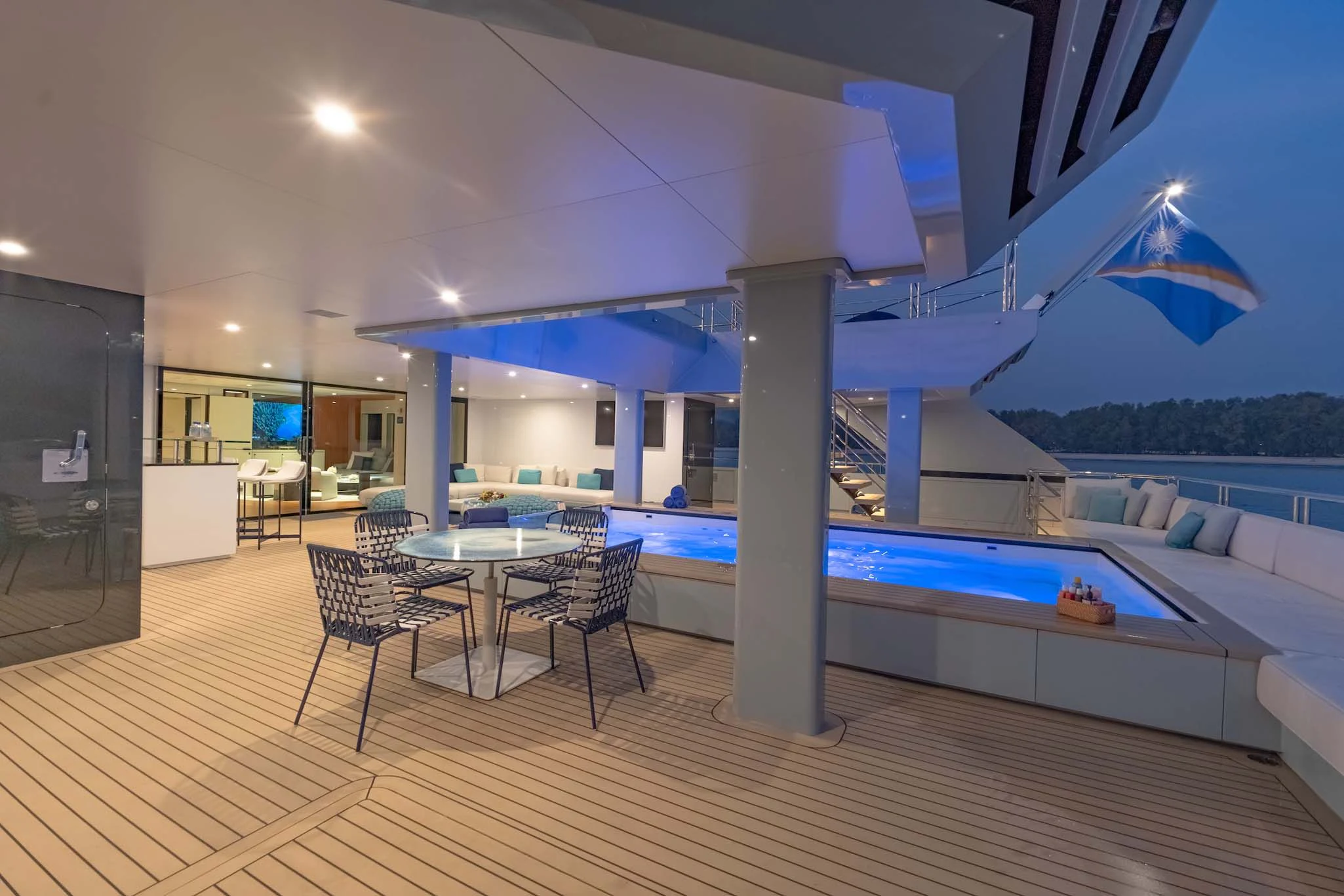 a large open room with a pool table and chairs aboard SPACECAT Yacht for Sale