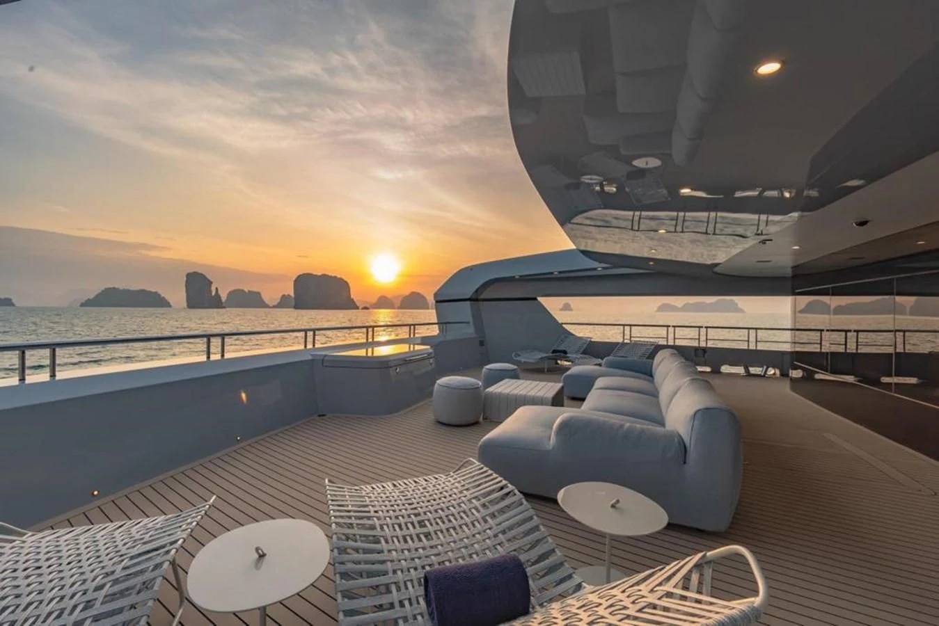a balcony with a view of the sunset and a large body of water aboard SPACECAT Yacht for Sale