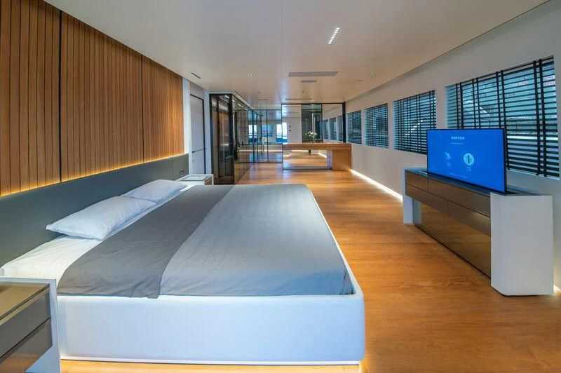 a bedroom with a bed and a tv aboard SPACECAT Yacht for Sale