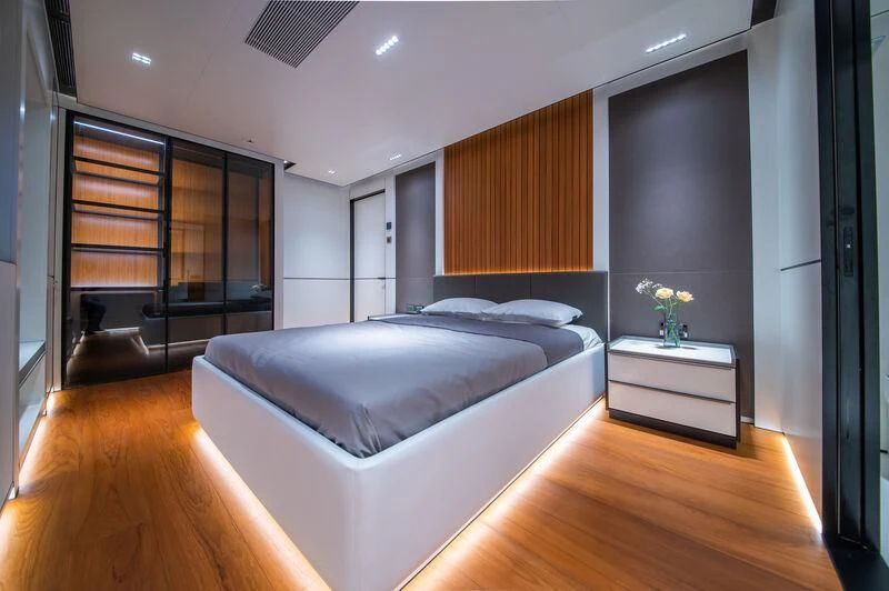 a bedroom with a large bed aboard SPACECAT Yacht for Sale