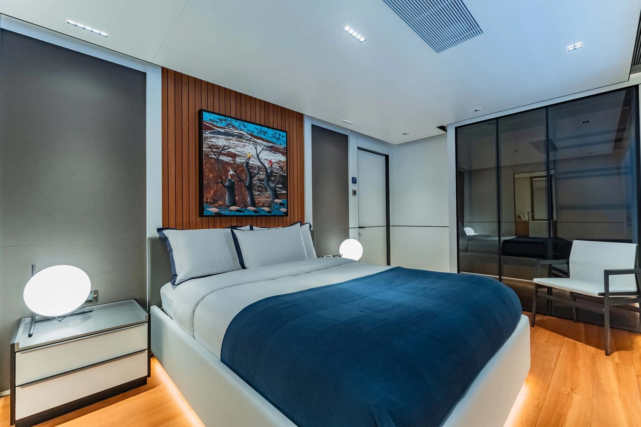 a bedroom with a bed and a desk aboard SPACECAT Yacht for Sale