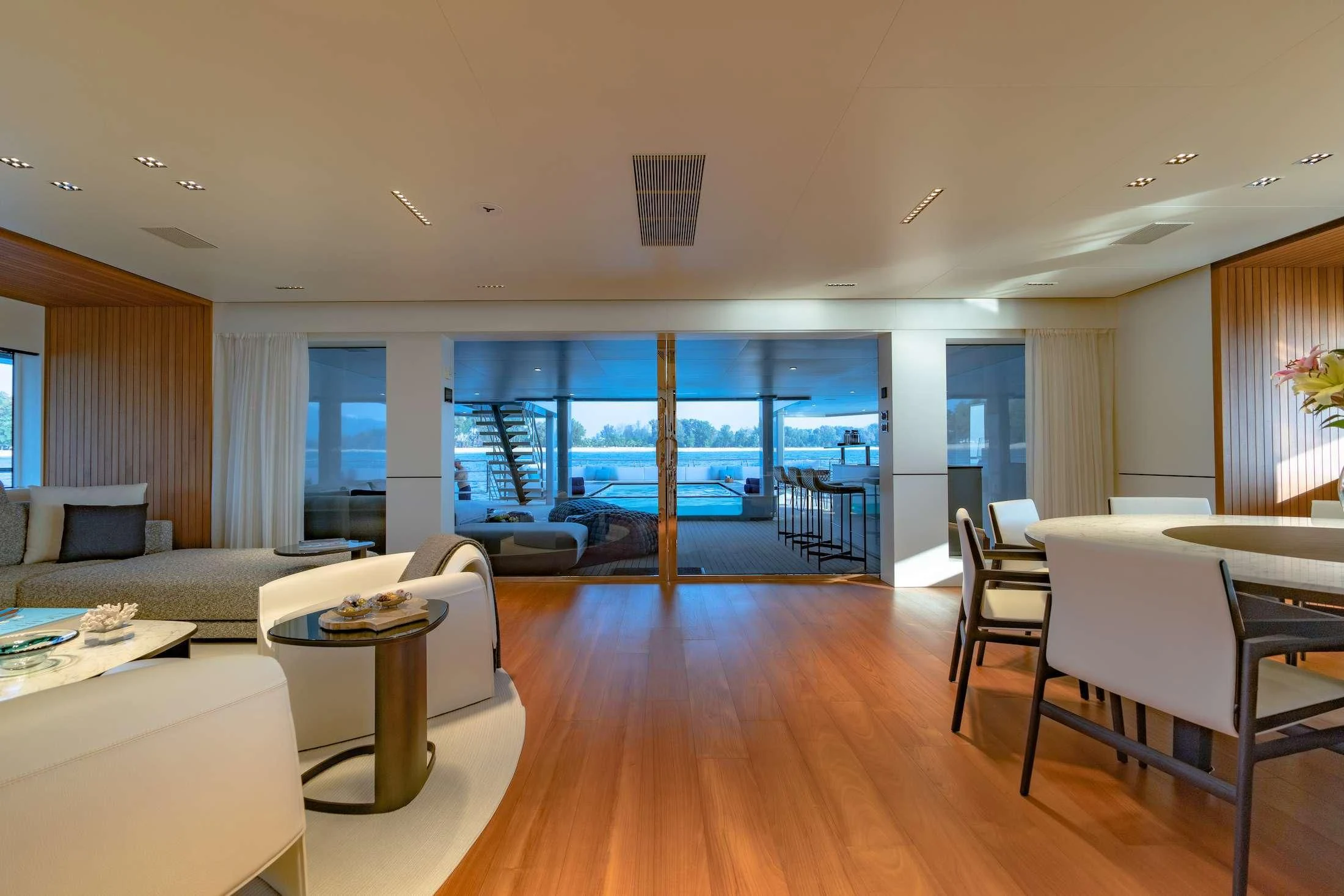 a room with a large window and a wood floor aboard SPACECAT Yacht for Sale