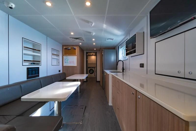 a large kitchen with a long counter aboard SPACECAT Yacht for Sale
