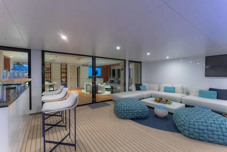 a modern living room with white furniture aboard SPACECAT Yacht for Sale
