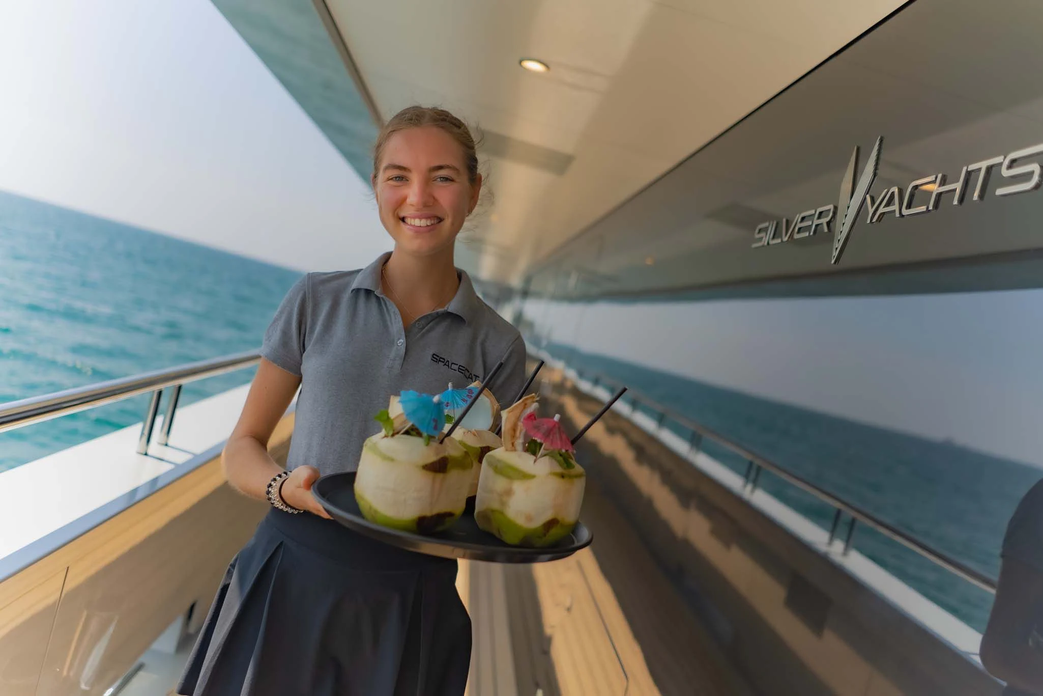 a person holding a cake aboard SPACECAT Yacht for Sale
