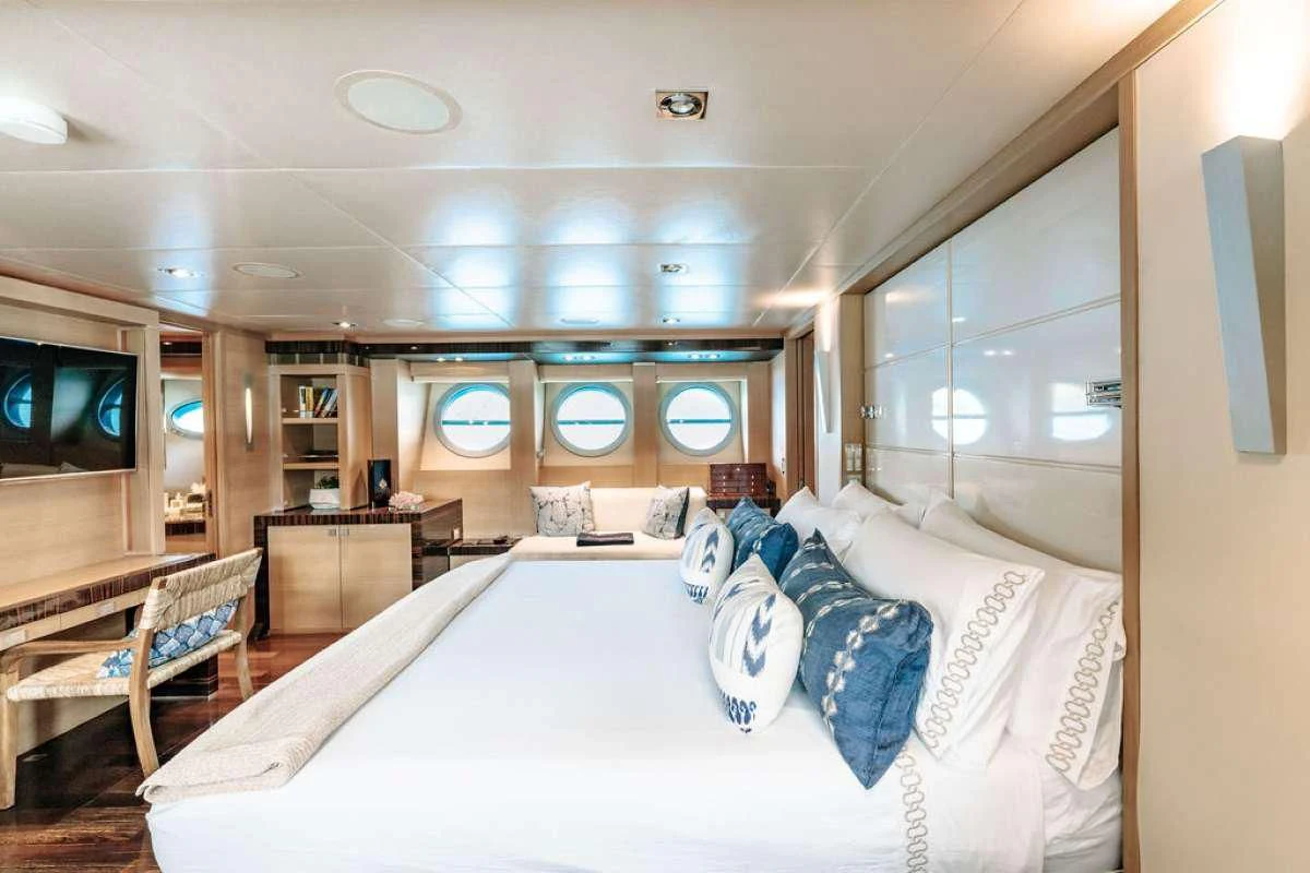a room with a bed and a television aboard VANTAGE Yacht for Sale
