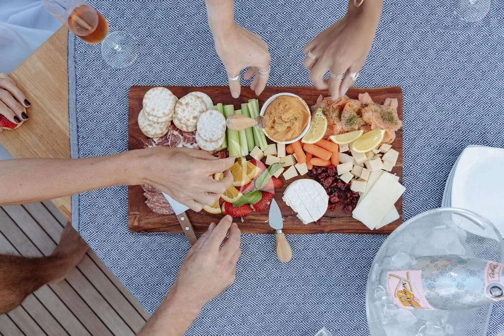 a person cutting a sandwich with a knife aboard VANTAGE Yacht for Sale