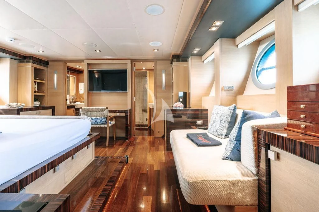 a large room with a bed and a tv aboard VANTAGE Yacht for Sale