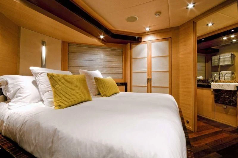 a bed with white sheets aboard VANTAGE Yacht for Sale