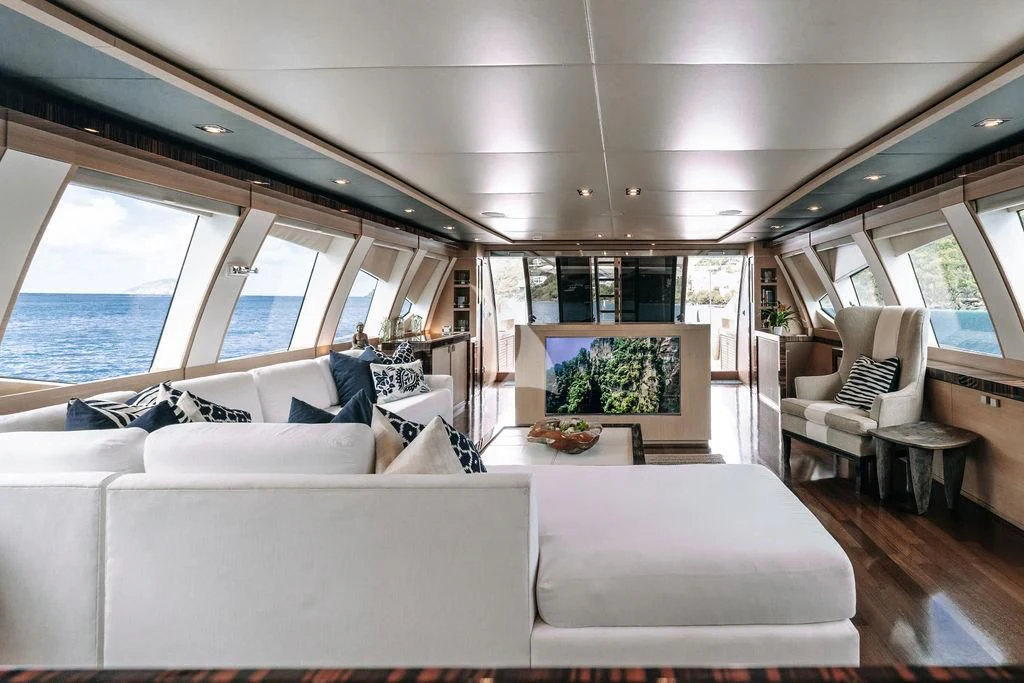 a room with couches and a table aboard VANTAGE Yacht for Sale