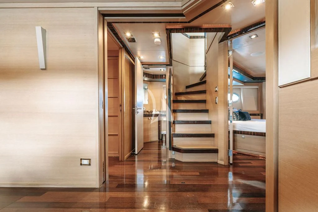 a room with a wood floor and a staircase aboard VANTAGE Yacht for Sale