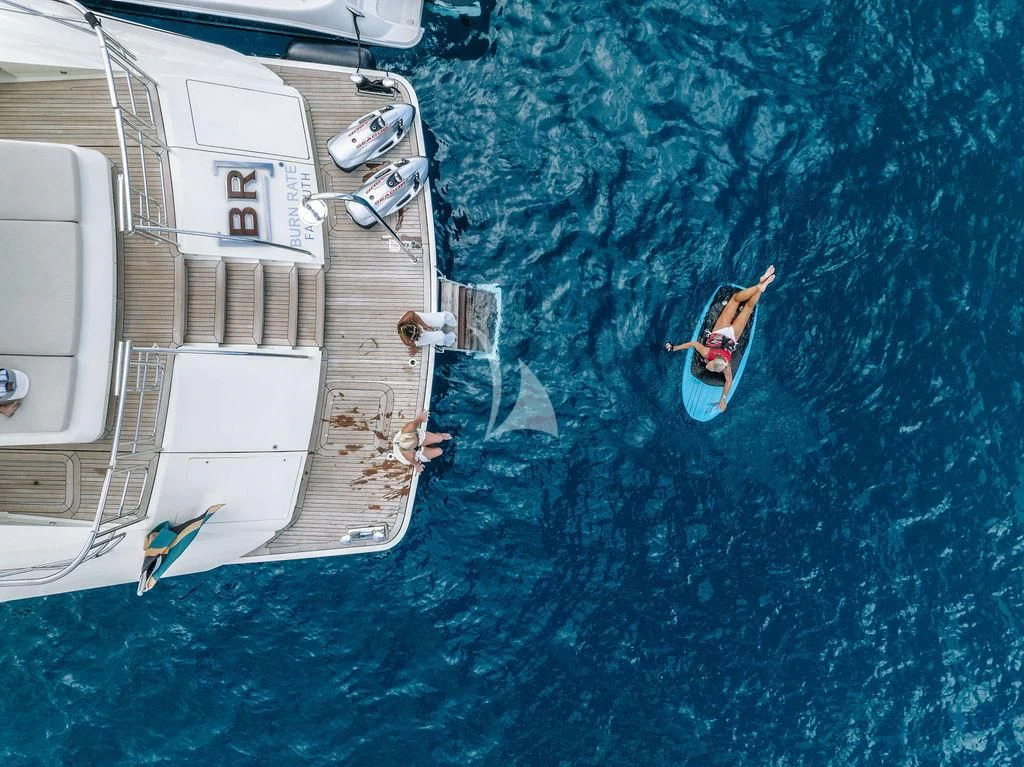a person jumping off a boat aboard VANTAGE Yacht for Sale