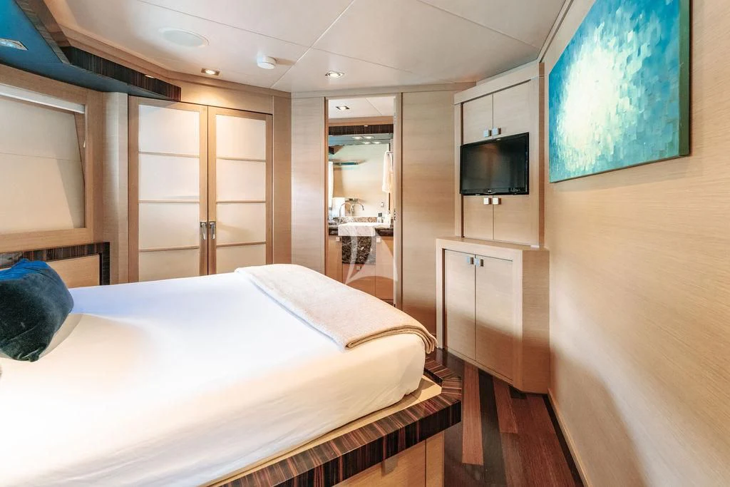 a bedroom with a bed and a television aboard VANTAGE Yacht for Sale