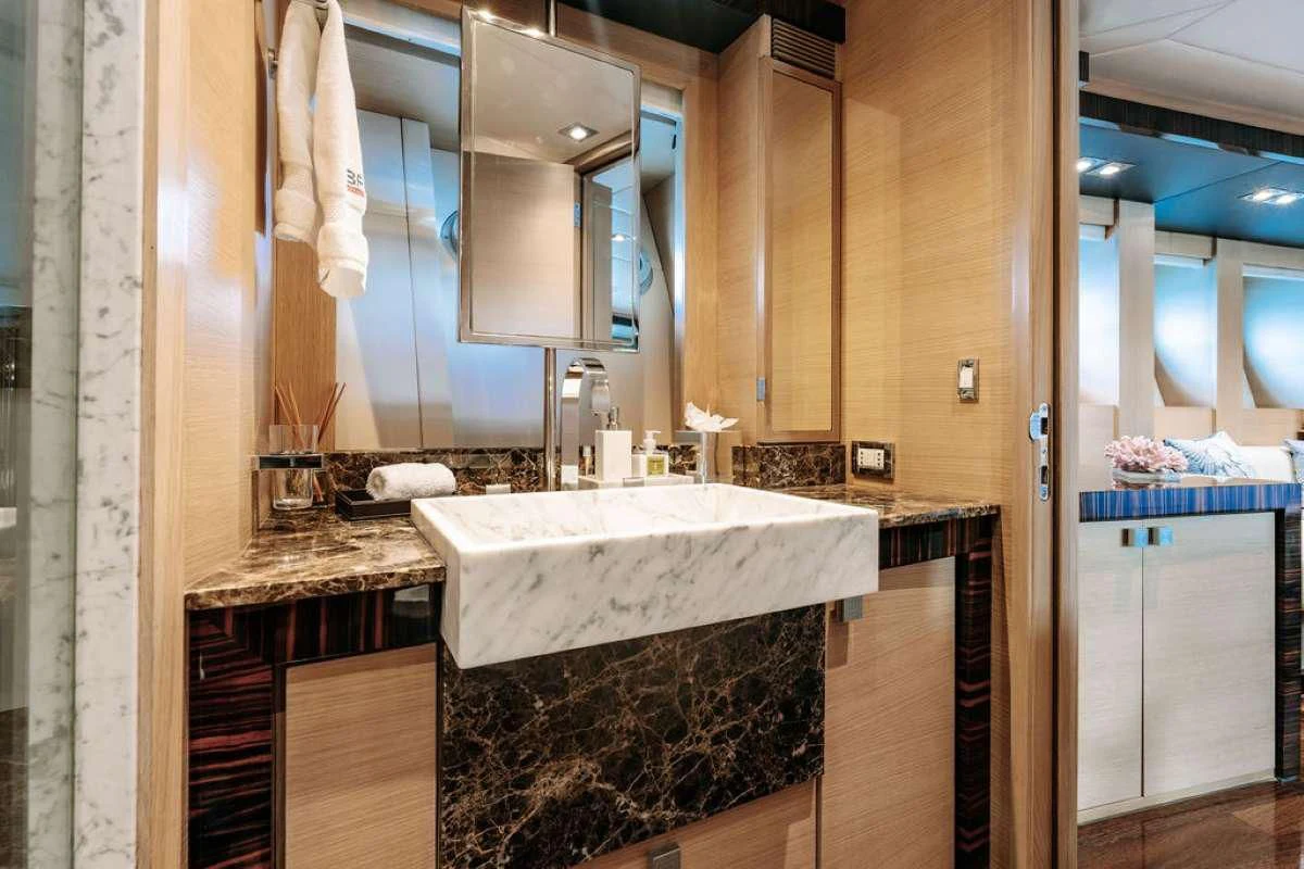 a bathroom with a tub sink and cabinets aboard VANTAGE Yacht for Sale