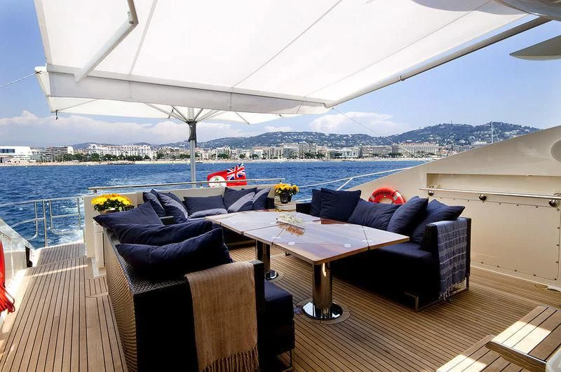 a patio with a table and chairs aboard VANTAGE Yacht for Sale