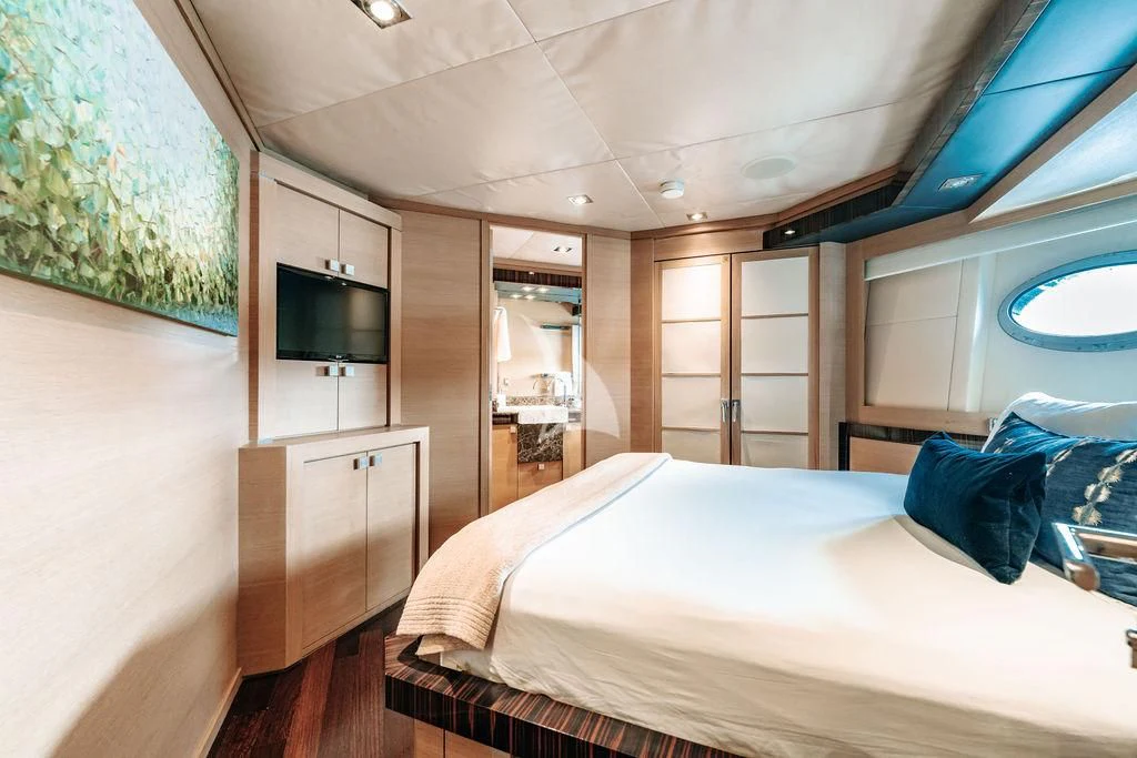 a bedroom with a bed and a television aboard VANTAGE Yacht for Sale